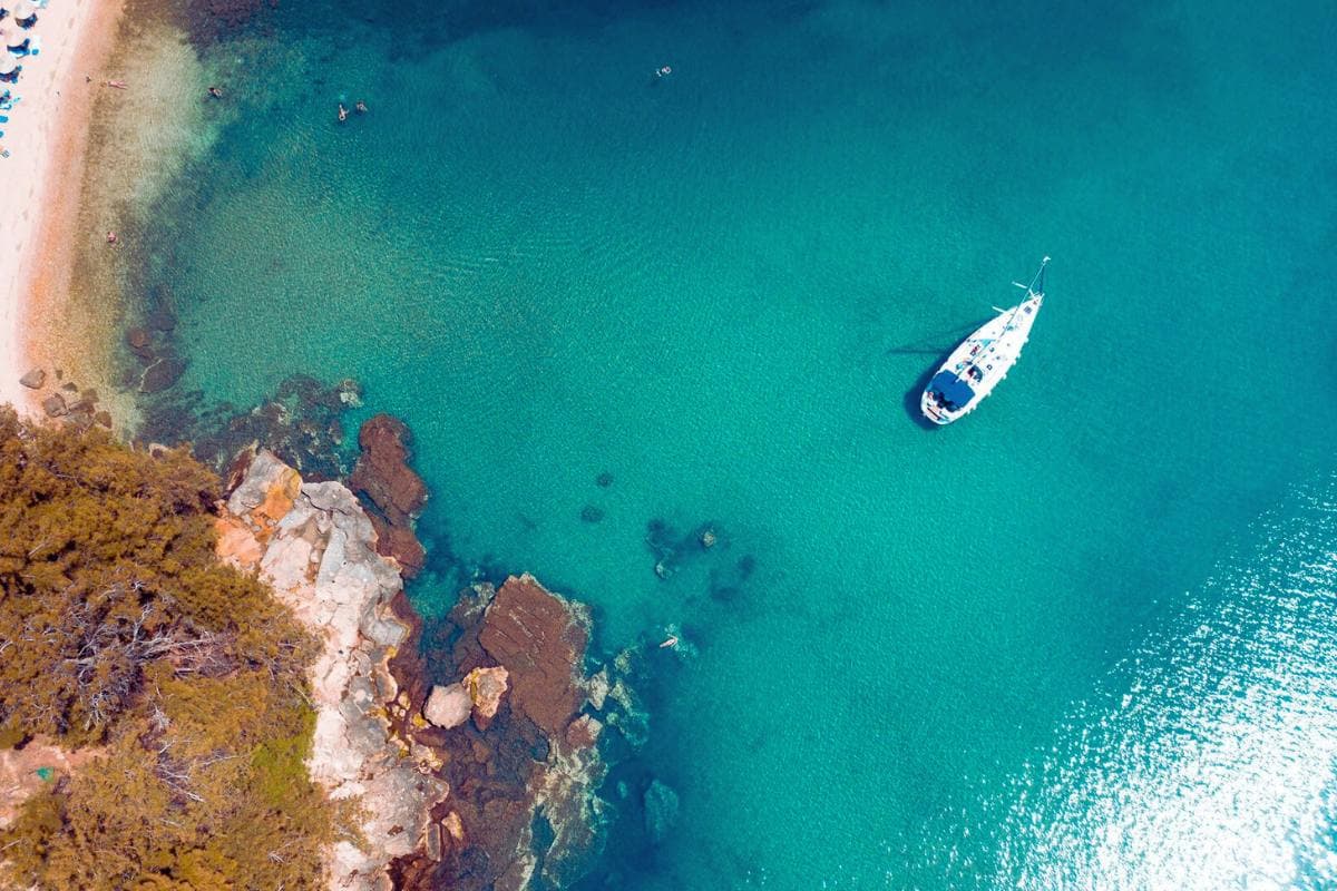 Luxury yacht cruising along the crystal-clear waters of Thassos coastline